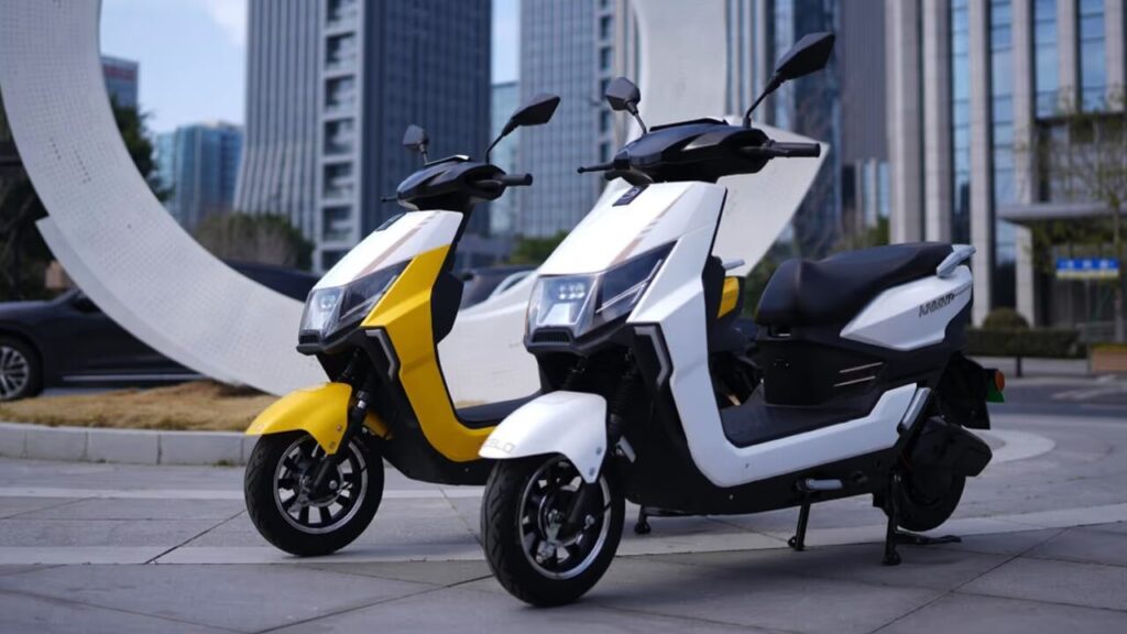 Zelo Knight+ electric scooter in glossy white parked in an urban city street