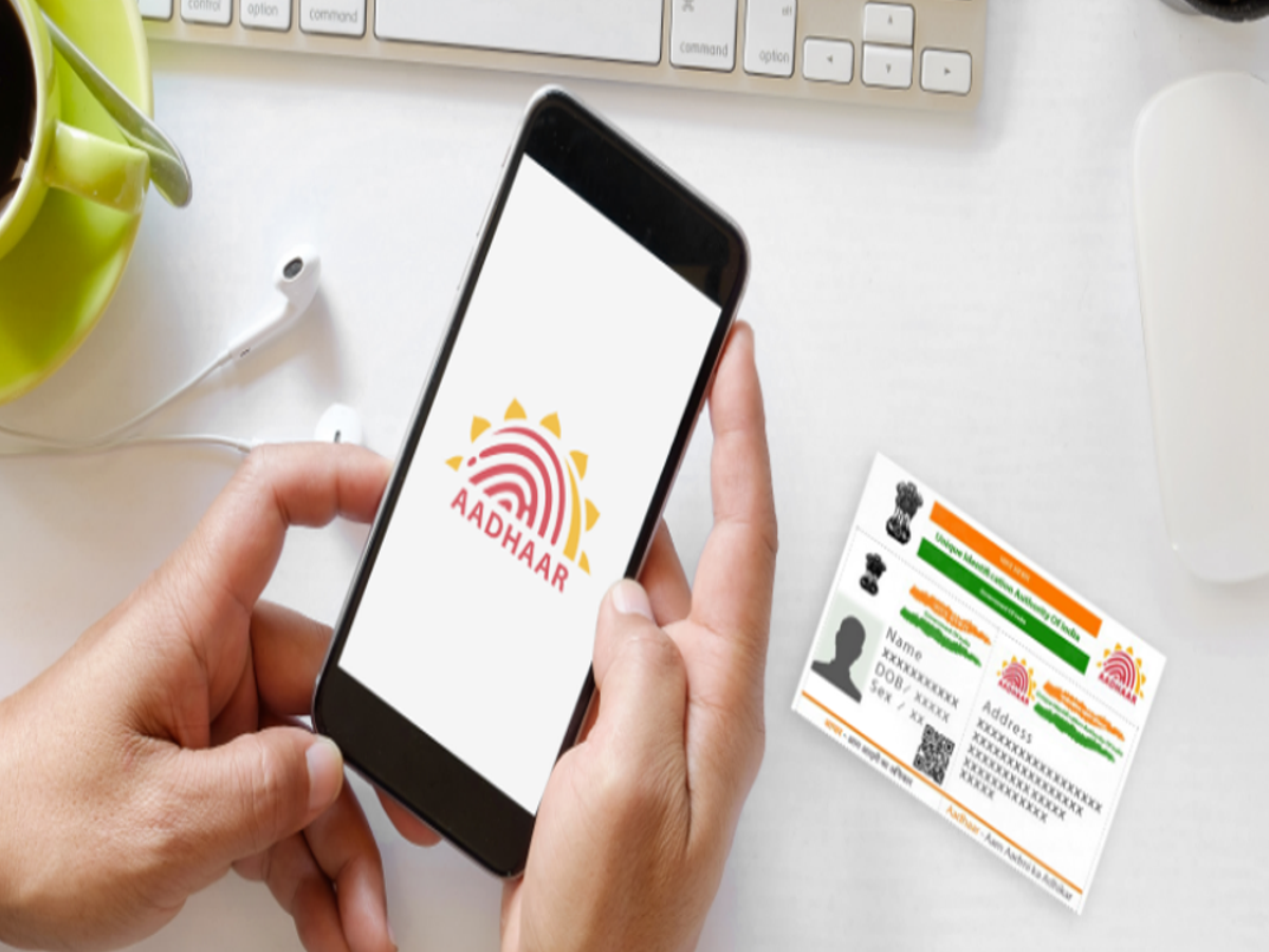Person updating Aadhaar card details on UIDAI portal using laptop