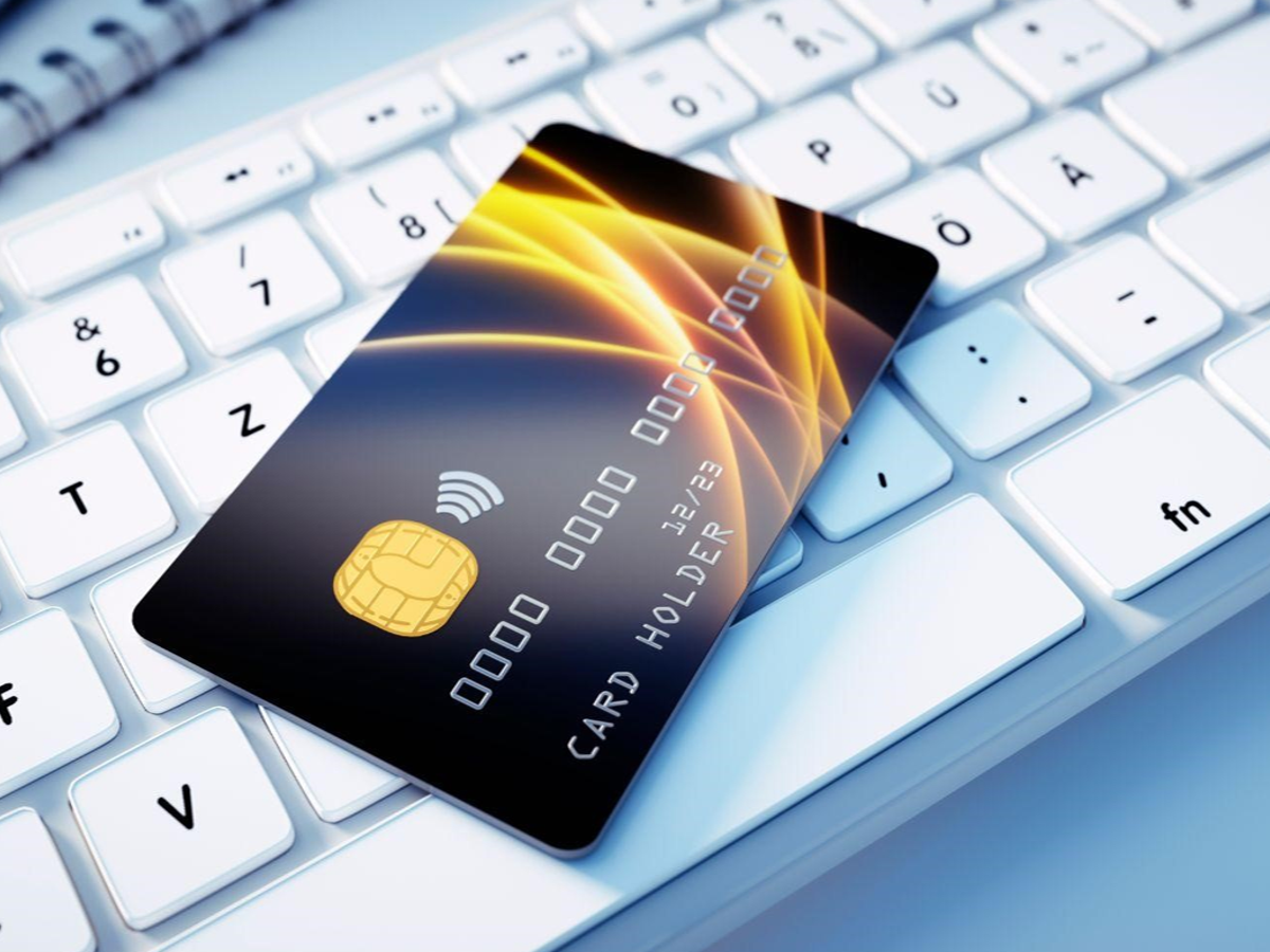 Person calculating credit card EMI options on a laptop