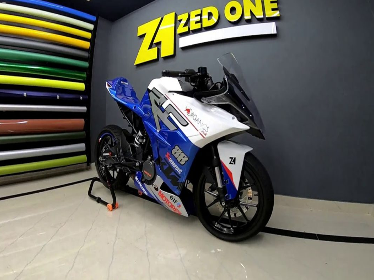 Close-up of Yamaha R15 V4 digital instrument cluster and quick-shifter, highlighting advanced features.