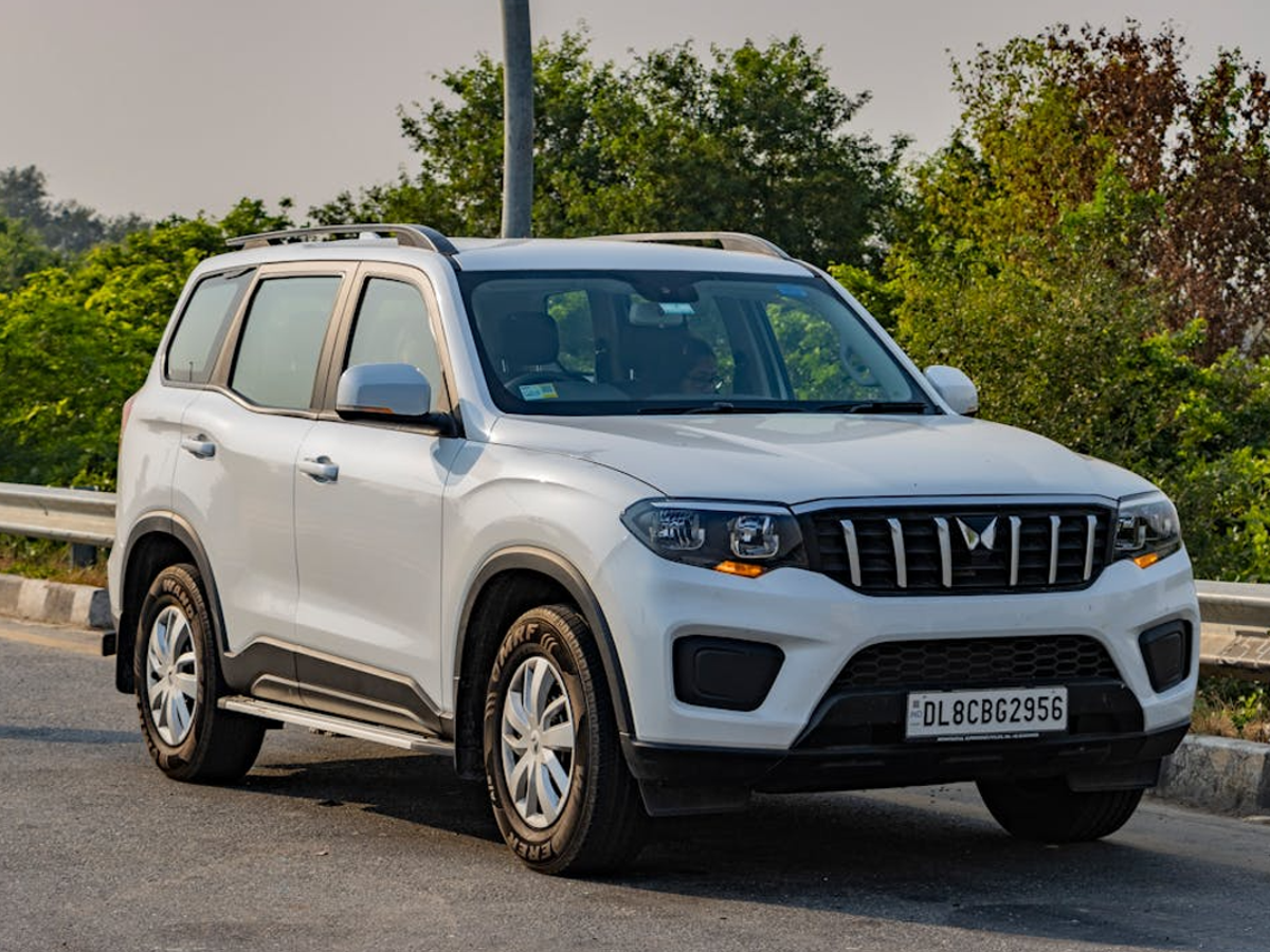 Interior comparison of Mahindra Scorpio and Thar, showcasing their cabin layouts, infotainment systems, and seating arrangements.