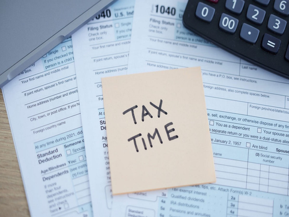 Person reviewing financial documents for income tax return filing, optimized for SEO.