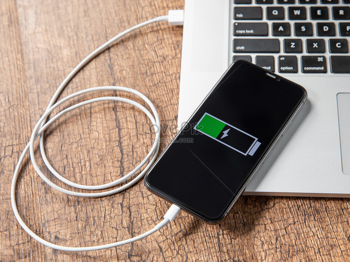 Power bank charging a phone, showcasing a portable and safe alternative to laptop charging.
