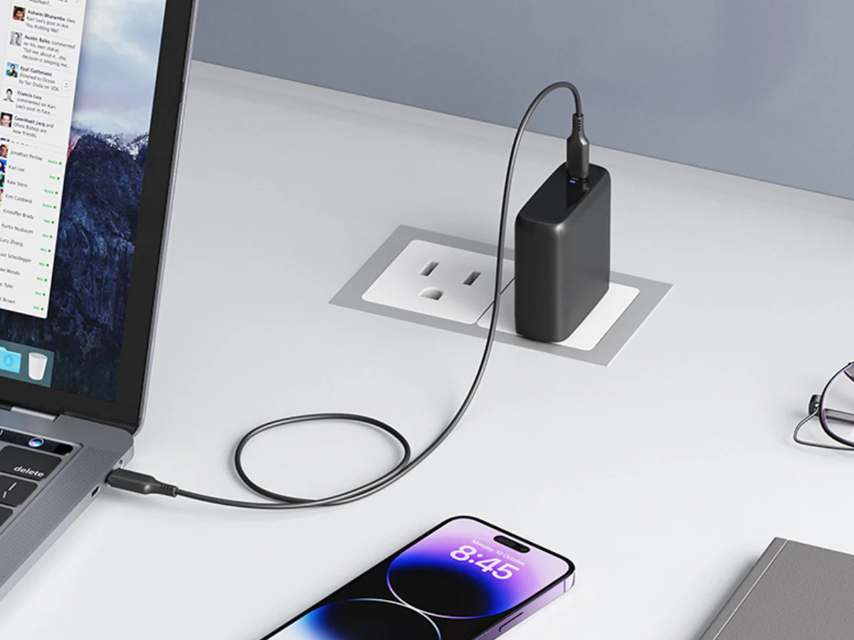 Smartphone connected to a laptop via USB cable, showing risks of battery damage and data transfer.