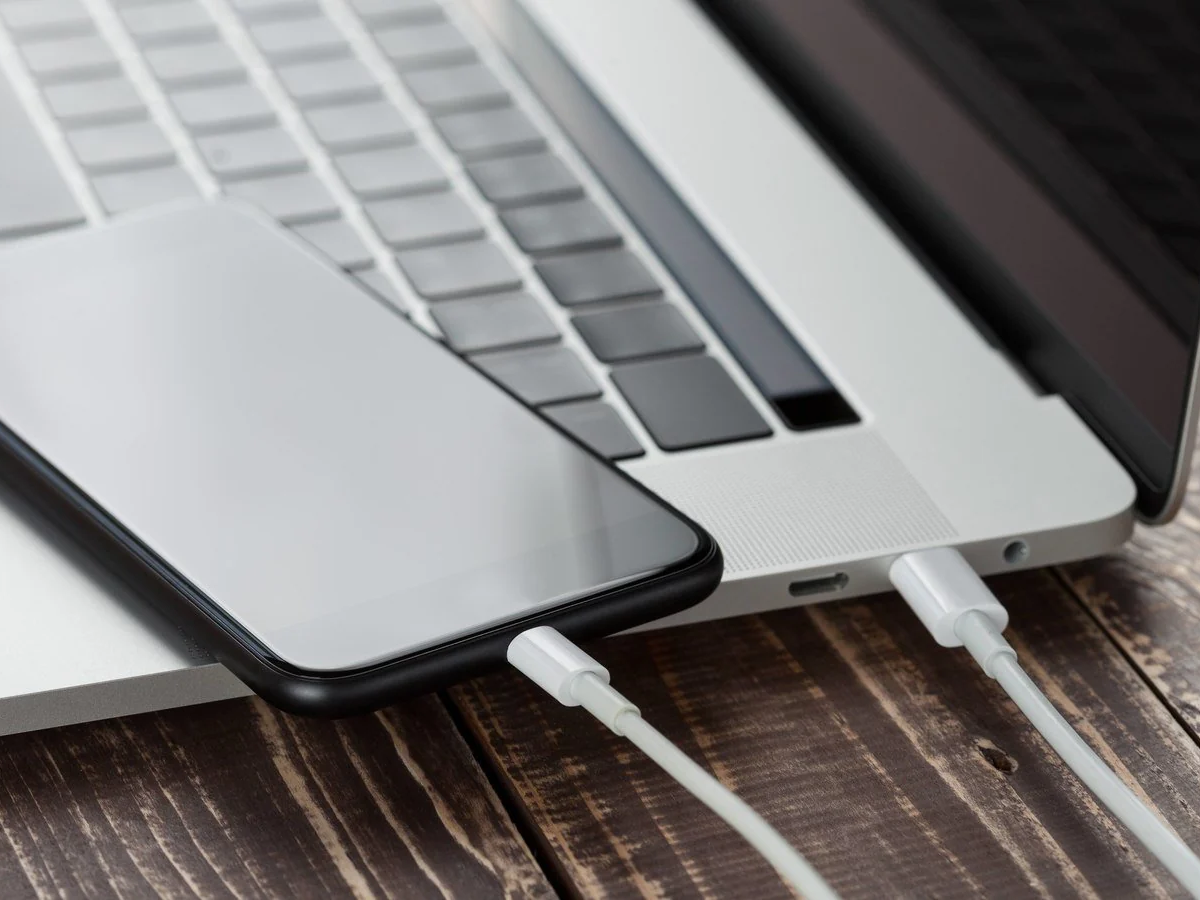 Wall charger plugged into a socket with a phone, illustrating safe charging practices.